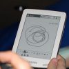 Samsung_E6_eReader_Natural_White_Front_Center_Side_Hand_Man_Model_Full_Body_Dandygadget_Portable_Media