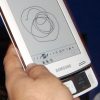 Samsung_E6_eReader_Natural_White_Front_Right_Hand_Man_Model_Full_Body_Dandygadget_Portable_Media